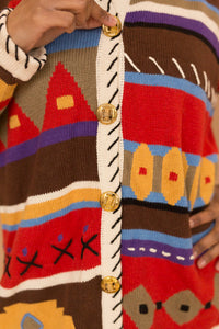 red & brown patterned sweater with gold buttons