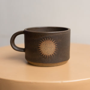 sun mug in lava rock