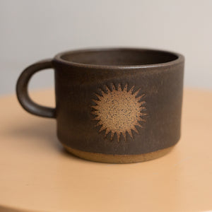 sun mug in lava rock