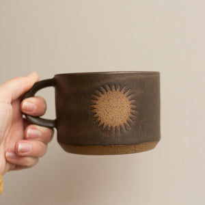 sun mug in lava rock