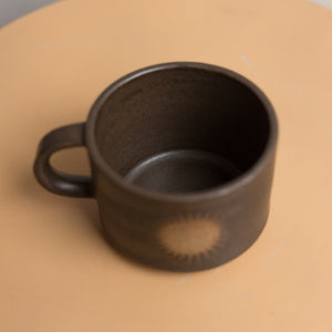 sun mug in lava rock