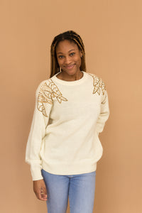 cream sweater with beaded shoulders